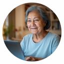 Senior woman using a laptop at home in Singapore after completing our computer basics course